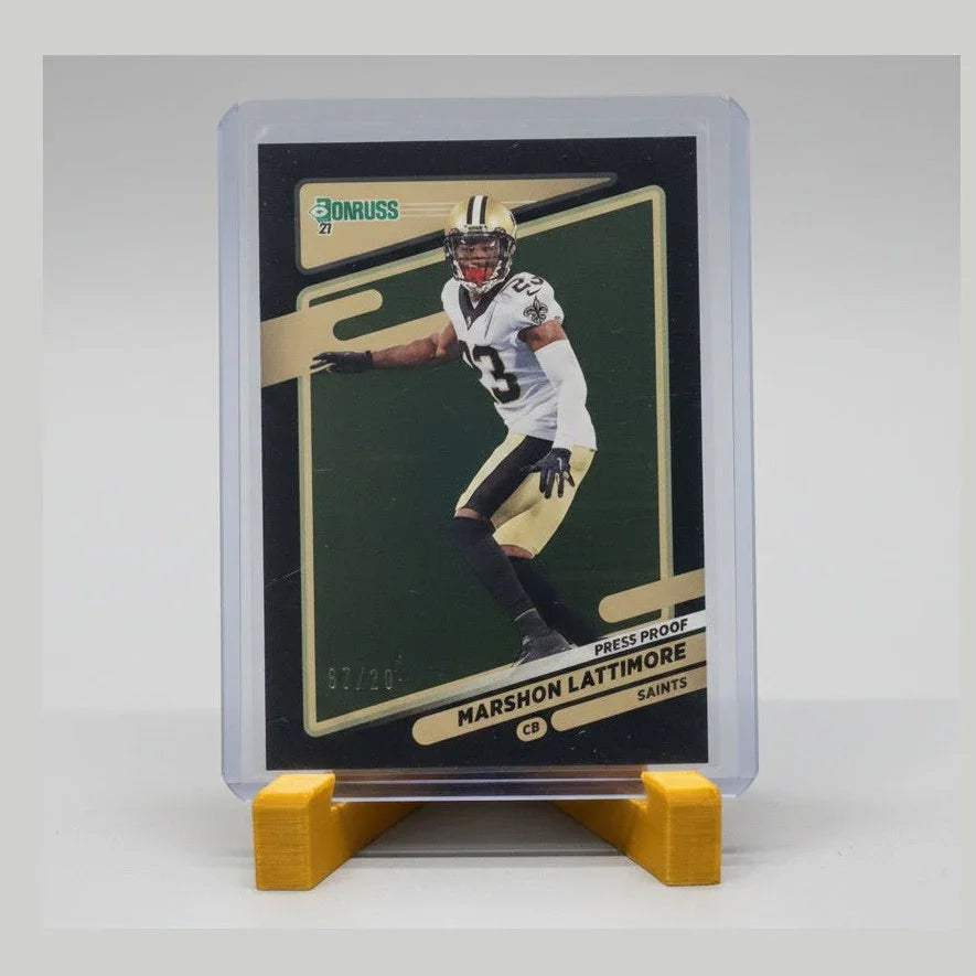 Trading card of a football player in a clear protective case on a dark surface
