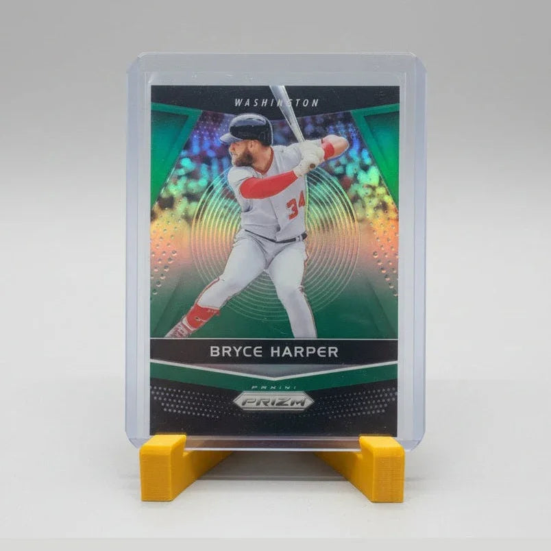 Baseball trading card of Bryce Harper in a clear case on a textured surface