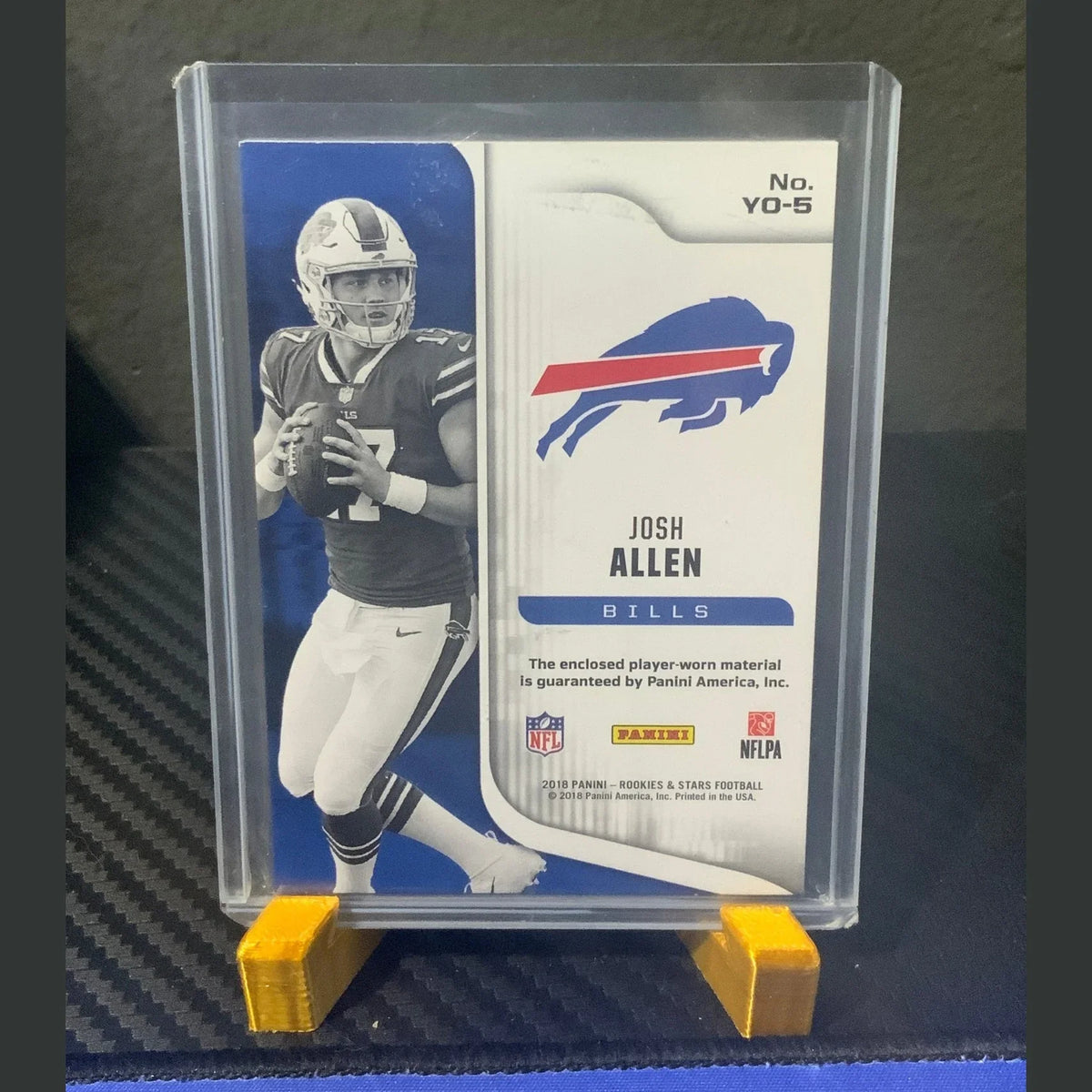 Football trading card of Josh Allen in a protective case on a dark surface