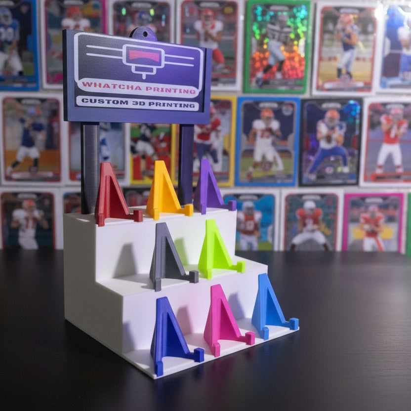 Colorful 3D-printed letter 'A' models on a stand with a branded label.