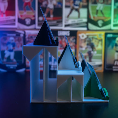 White and green plastic component on a dark background