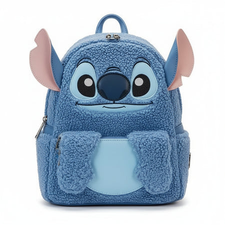 Blue plush backpack with cartoon face design on a white background