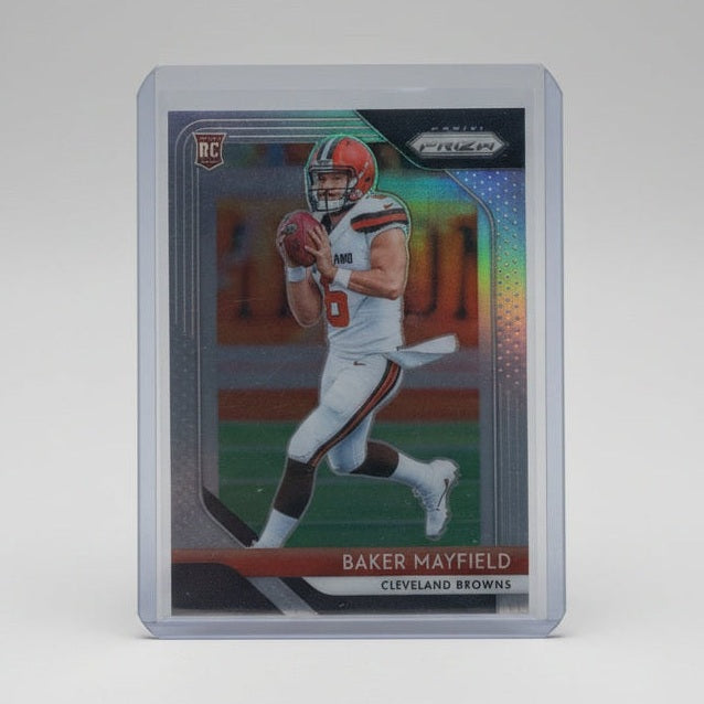 Trading card of a baseball player in a clear protective case on a dark surface