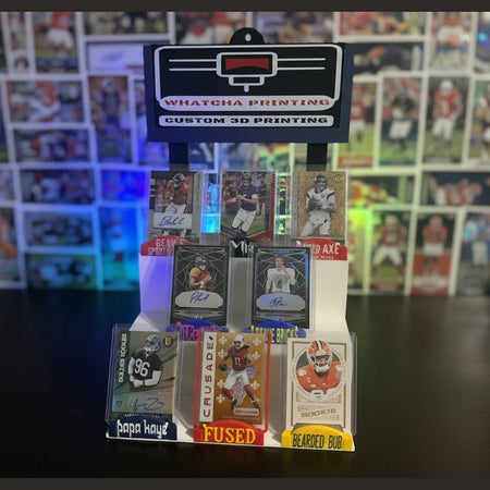 Collection of sports trading cards in an open album with a 'Whatshisname' branded card holder.