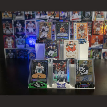 Collection of sports trading cards on a stand against a dark background