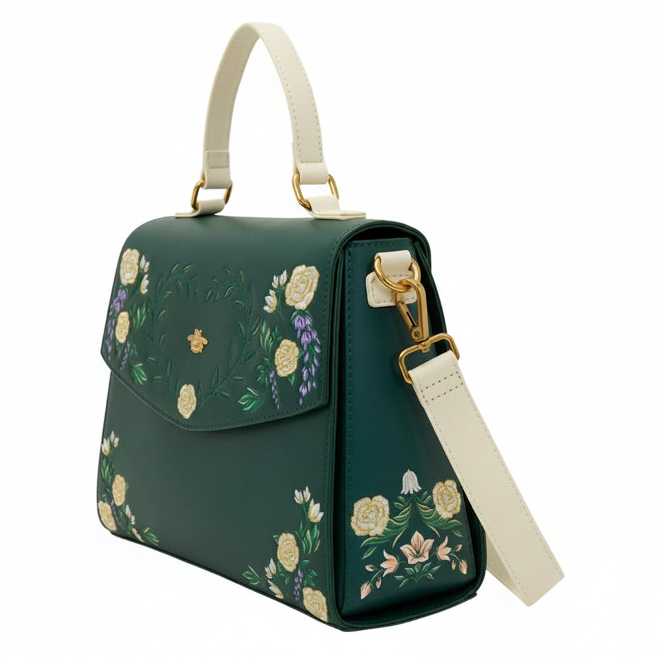 Green handbag with floral embroidery on a white background