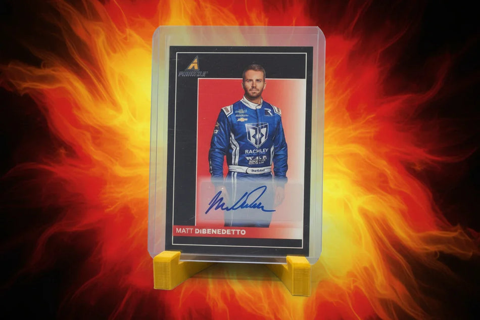 Trading card of a person in a blue jacket on a red background, held by a yellow holder.