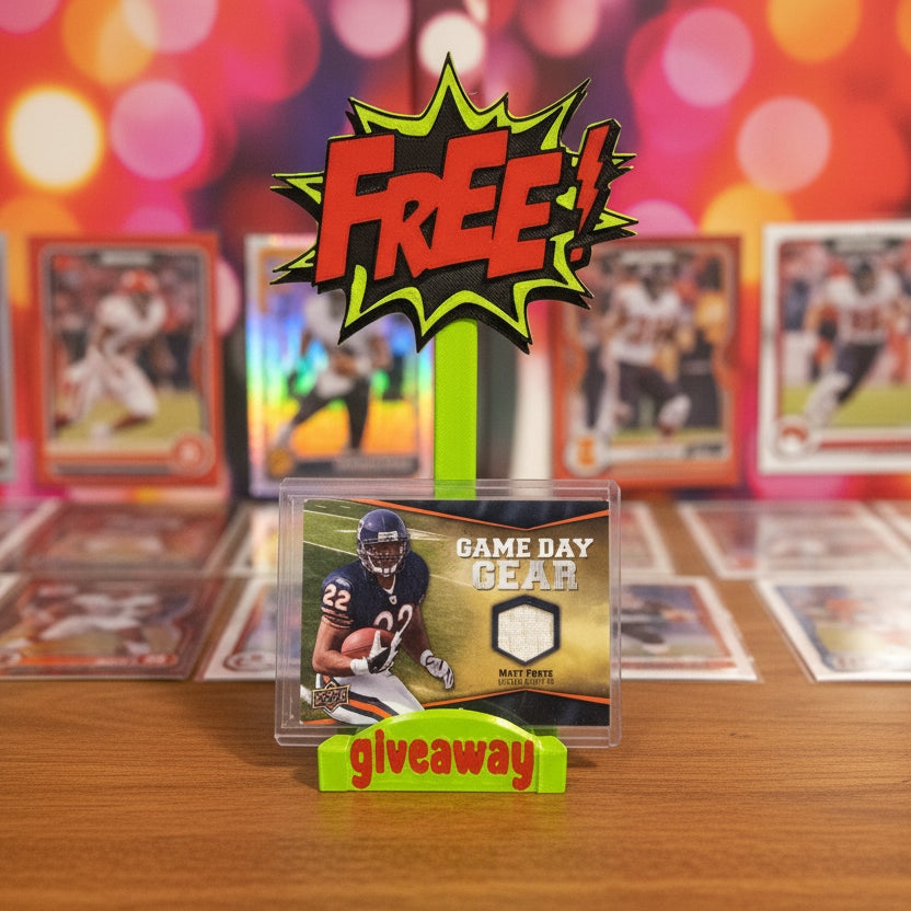 Collection of sports trading cards with a 'Free Game Day Gear Giveaway' sign on a wooden surface.