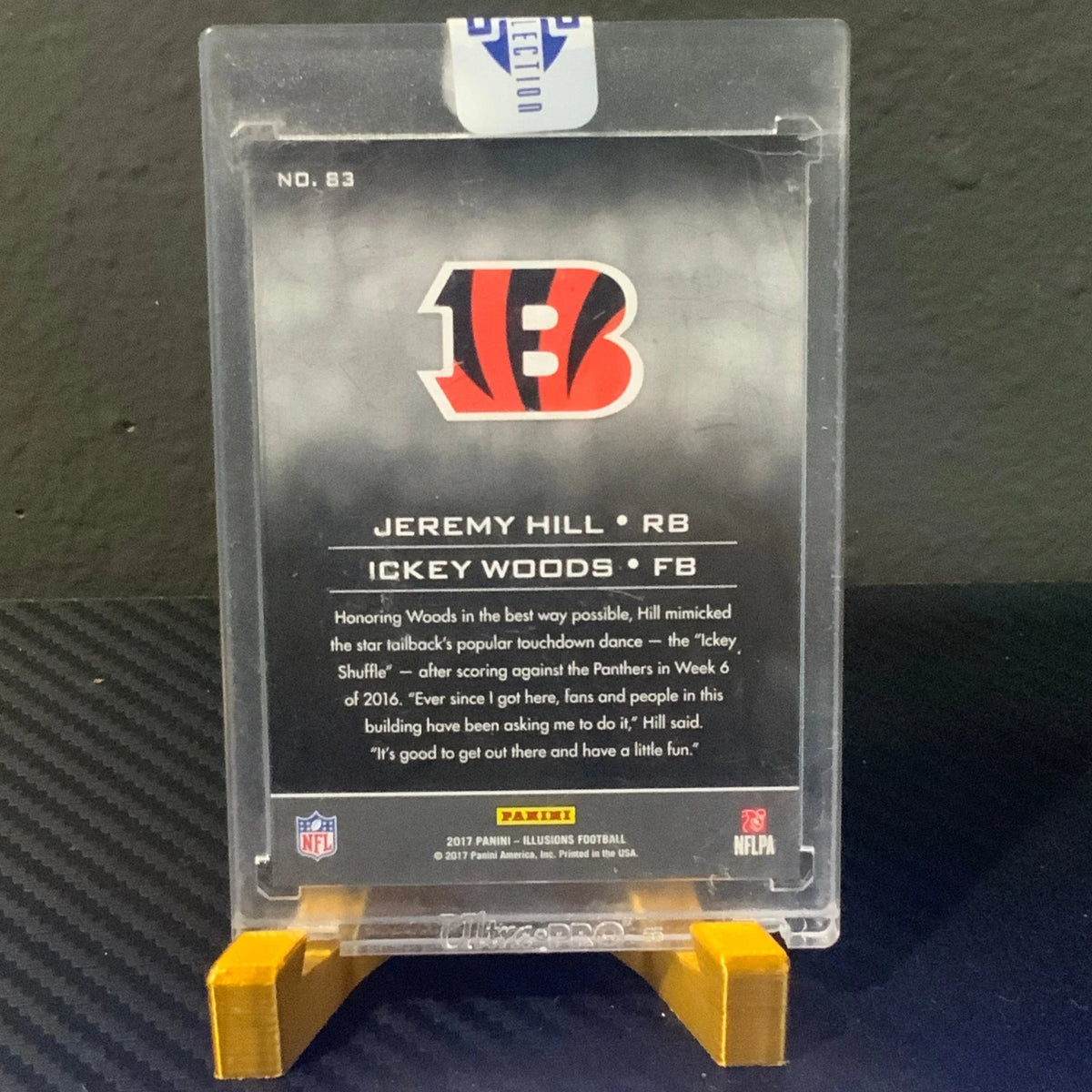 Trading card of Jeremy Hill and Ickey Woods on a clear display stand with NFL logo.