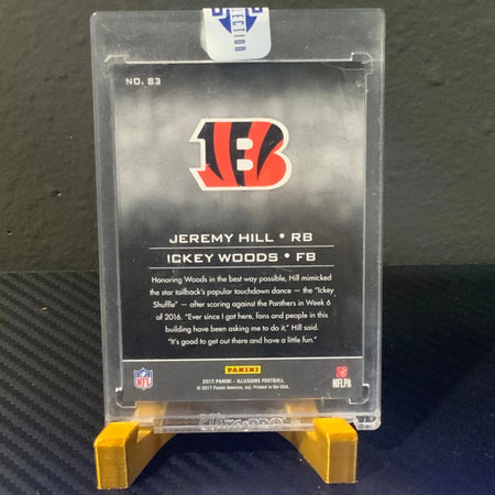 Trading card of Jeremy Hill and Ickey Woods on a clear display stand with NFL logo.