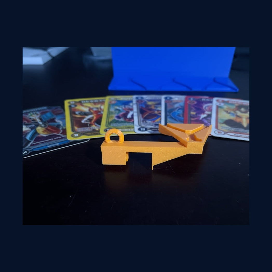 Gold 3D-printed letter 'A' next to a blue 3D-printed object on a dark background