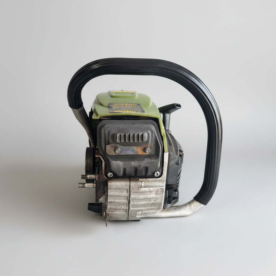 Close-up of a power tool attached to a wall with cardboard boxes in the background