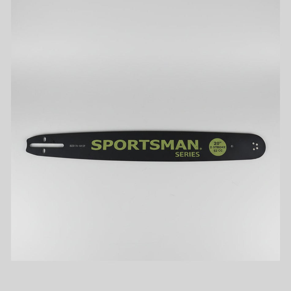 Sportsman series chainsaw bar on a concrete floor with a magazine underneath.