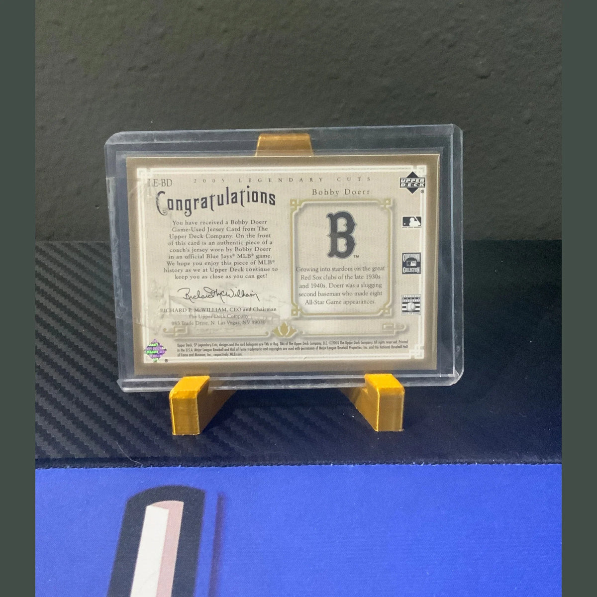 Trading card in a protective holder with a dark background