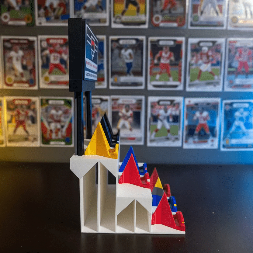 Toy figure on a stand with sports trading cards in the background