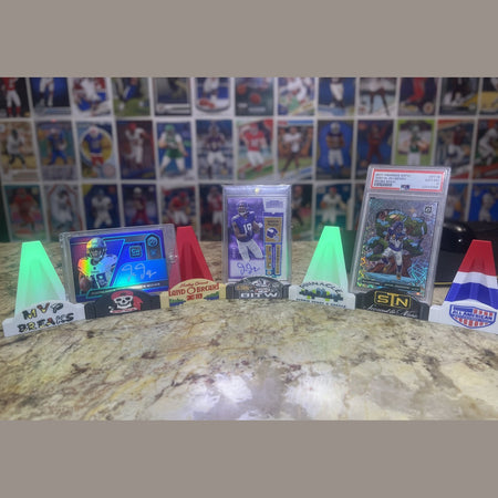 Football trading cards on a kitchen counter with a laptop in the background