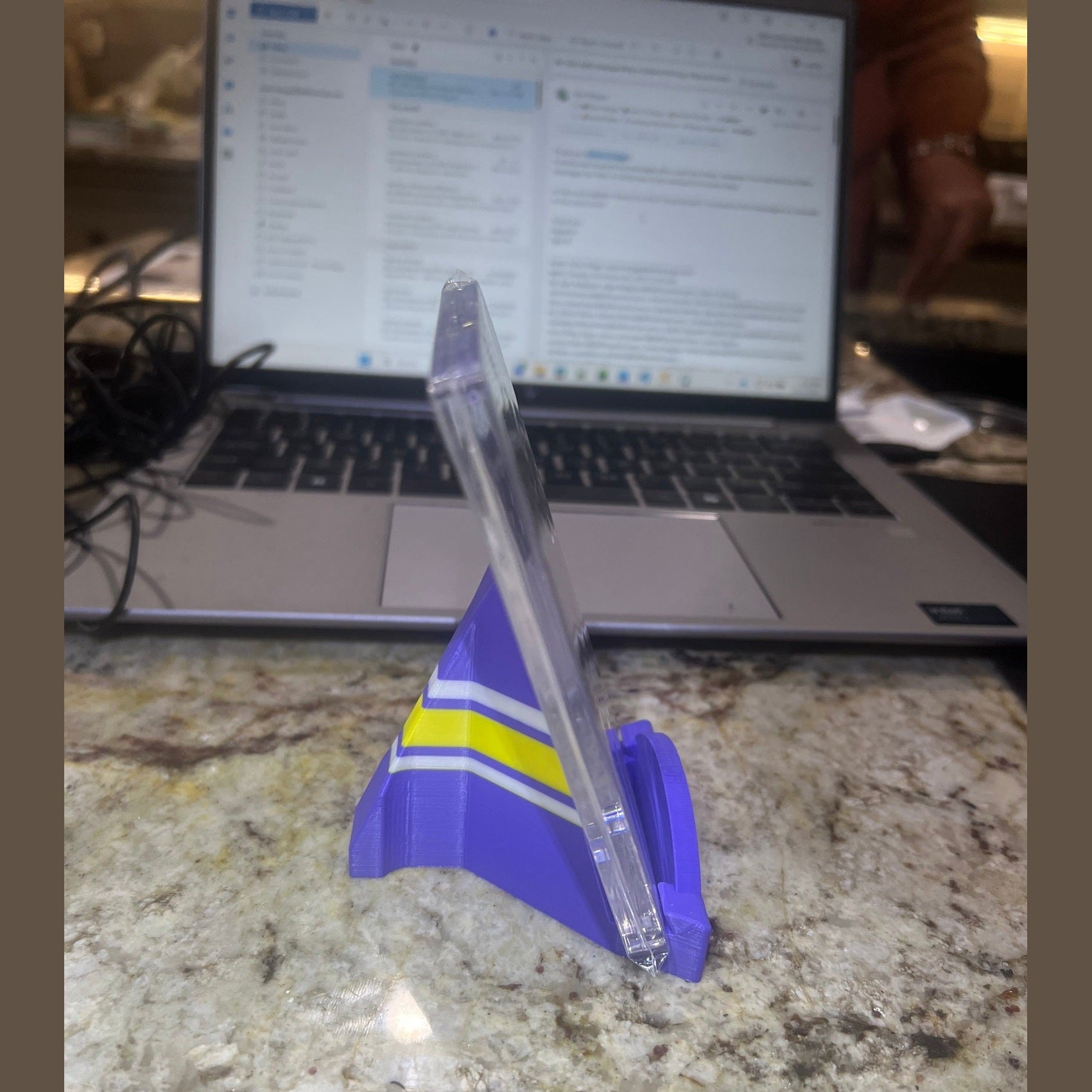 Clear ruler with blue and yellow accents on a laptop and marble surface