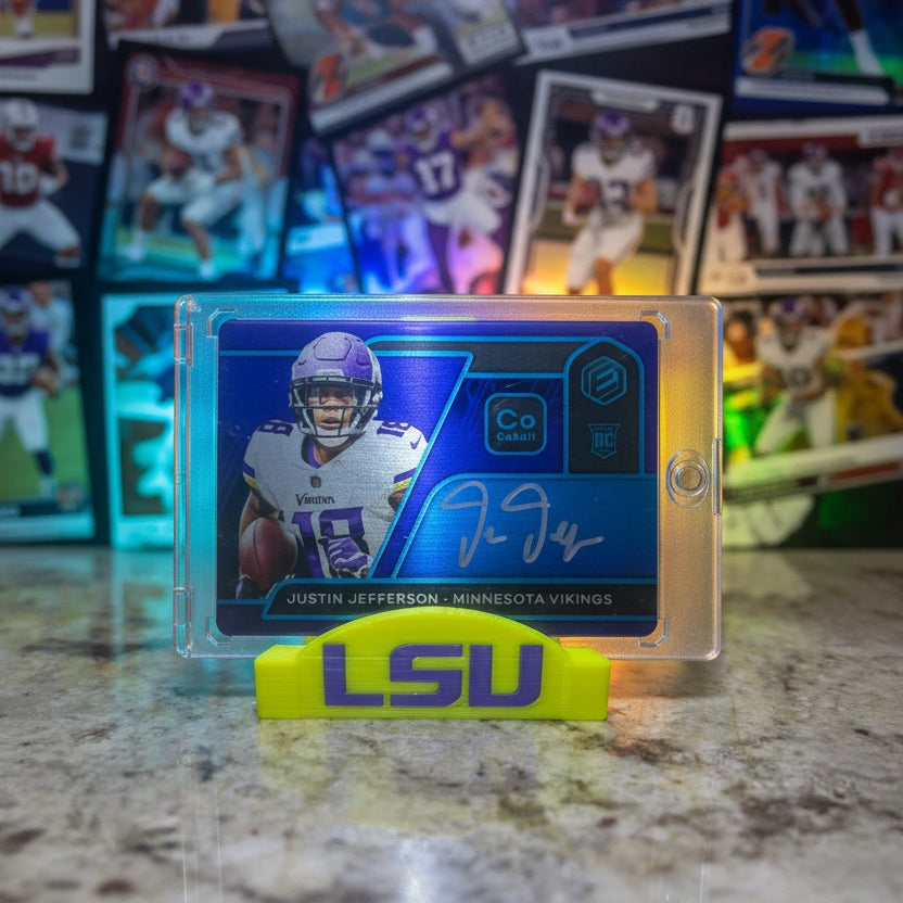 Trading card of a football player with a yellow highlighter on a laptop and marble surface