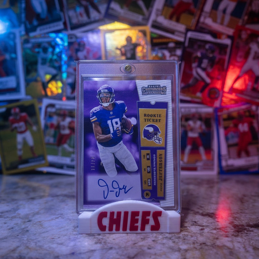 Football trading card of a player in a Chiefs uniform surrounded by other cards on a textured surface.