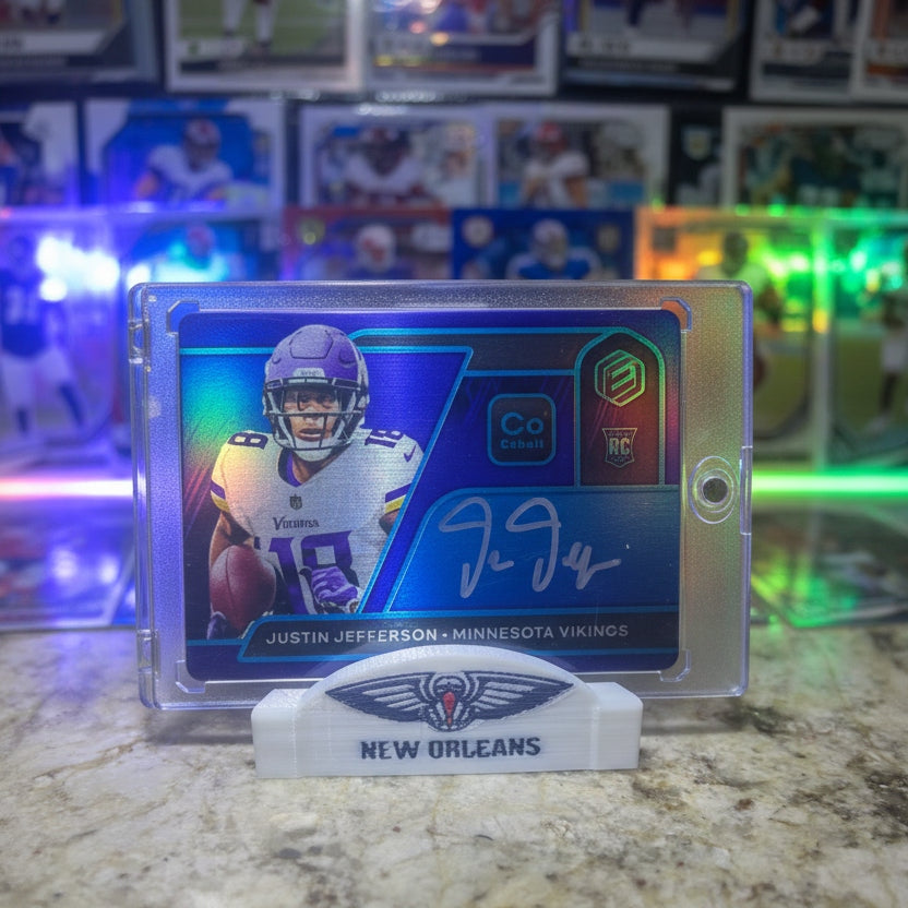 Collectible sports card featuring a player in a Minnesota Vikings uniform on a marble surface with a colorful background.