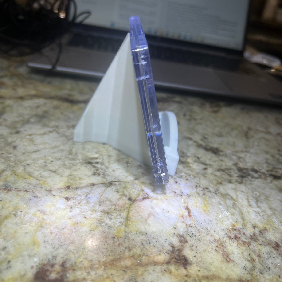 Clear plastic object on a textured surface with a blurred background