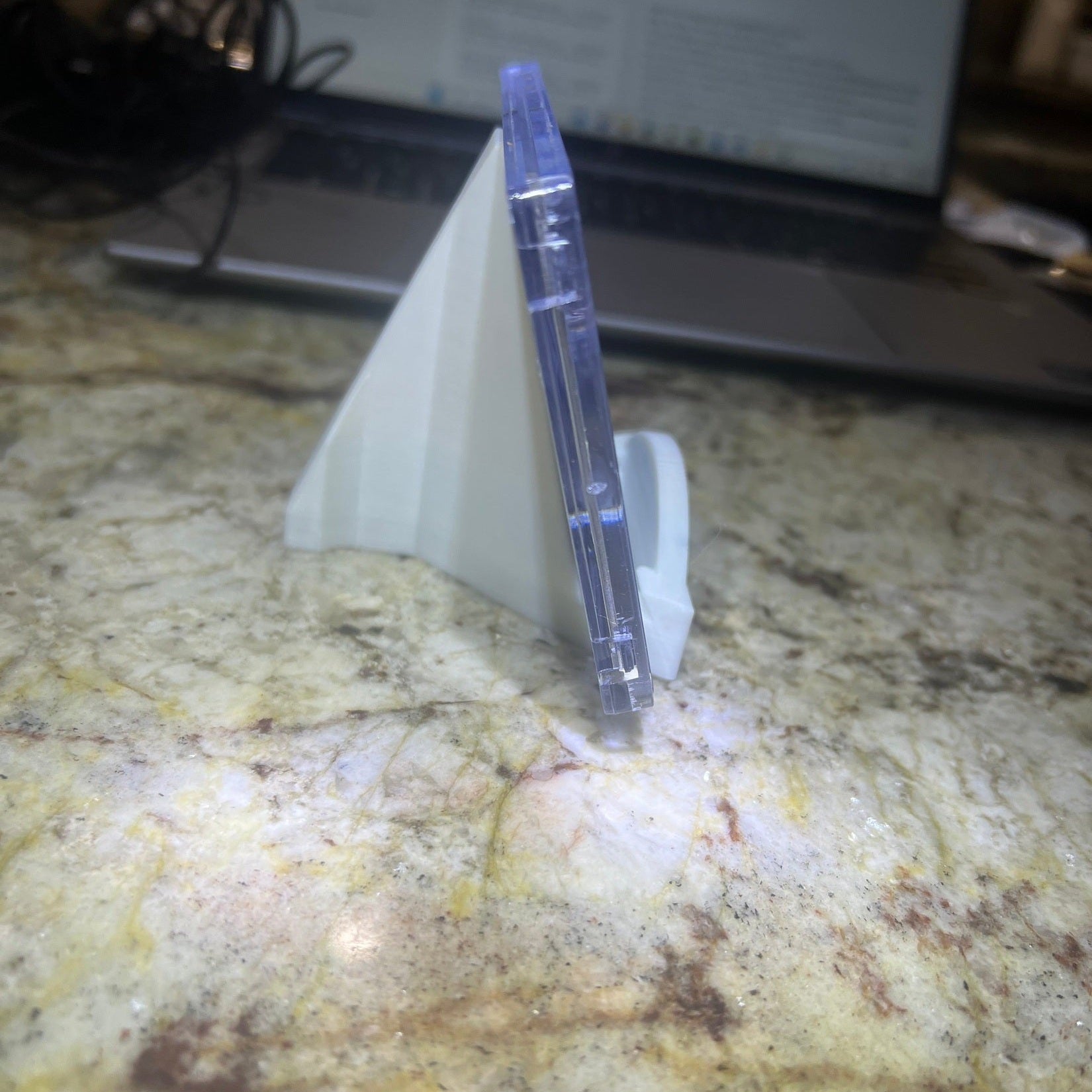 Clear plastic object on a textured surface with a blurred background