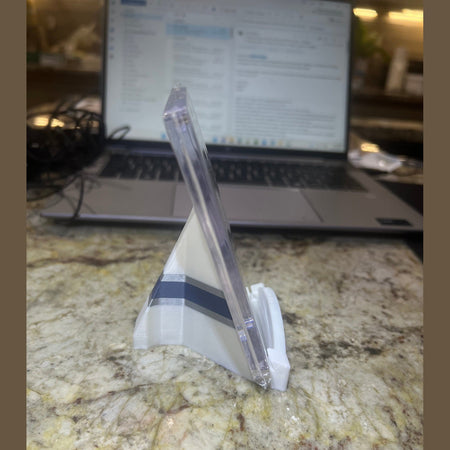 Clear plastic knife on a marble surface with a blurred laptop in the background