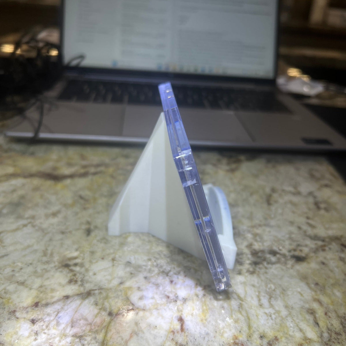 Clear plastic container with a white lid on a marble surface