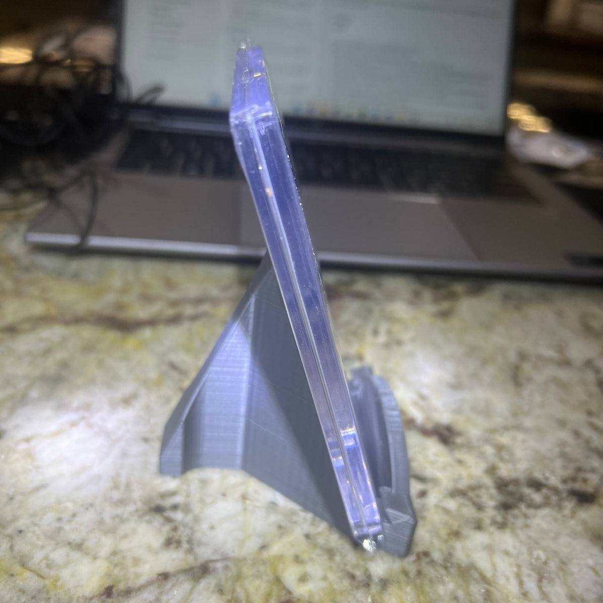 Clear plastic tool on a marble surface with a blurred background