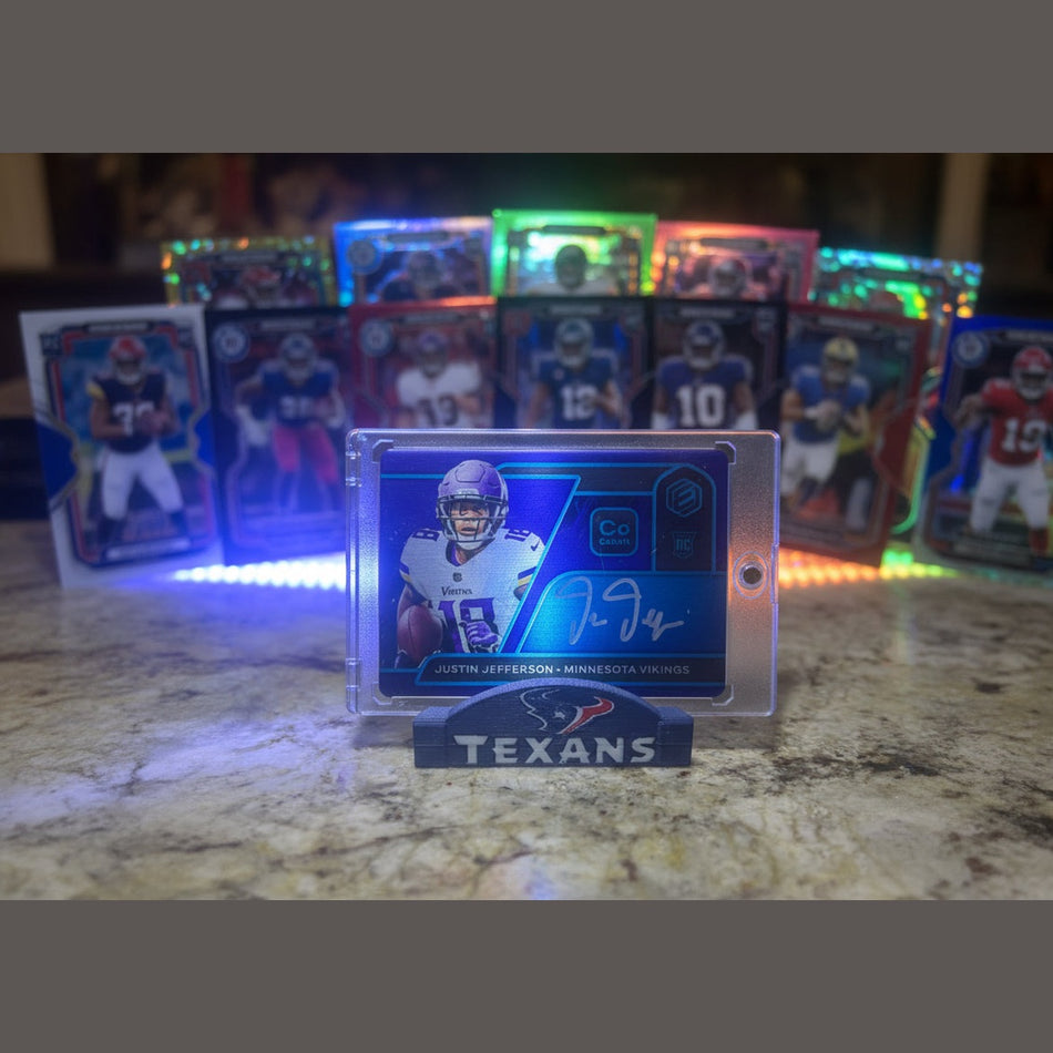 Trading card of a football player in a clear protective case on a marble surface