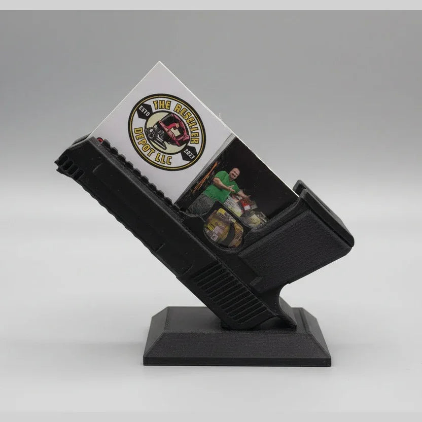 Black display stand holding a white card with a logo and text on a gray background