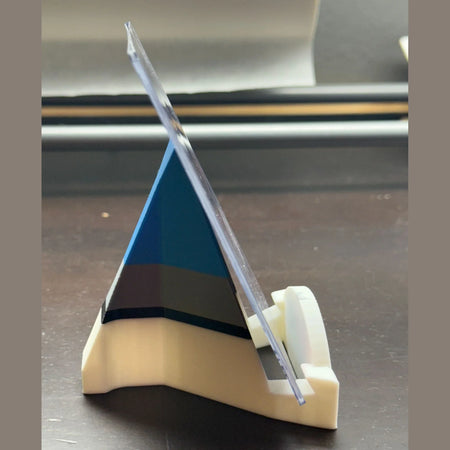 3D-printed object with a clear plastic component on a metallic surface