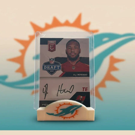Trading card of O.J. Howard with a Miami Dolphins logo on a stand.