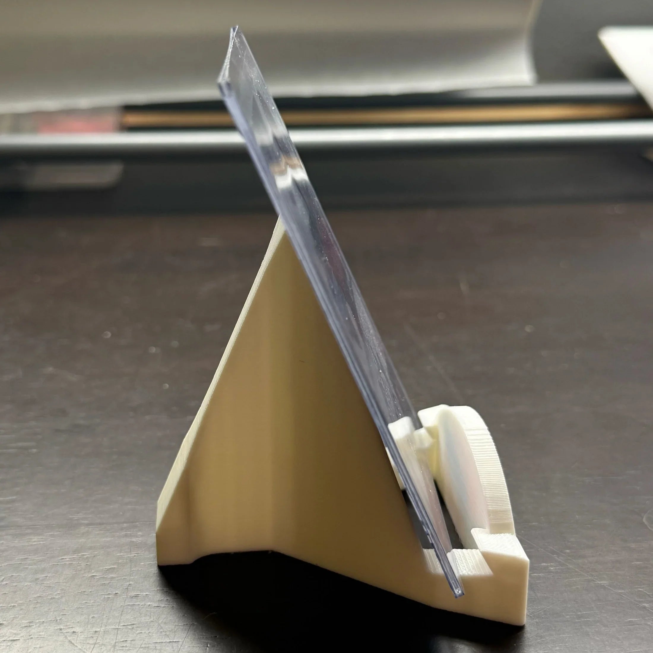 Clear plastic ruler on a beige stand against a blurred background