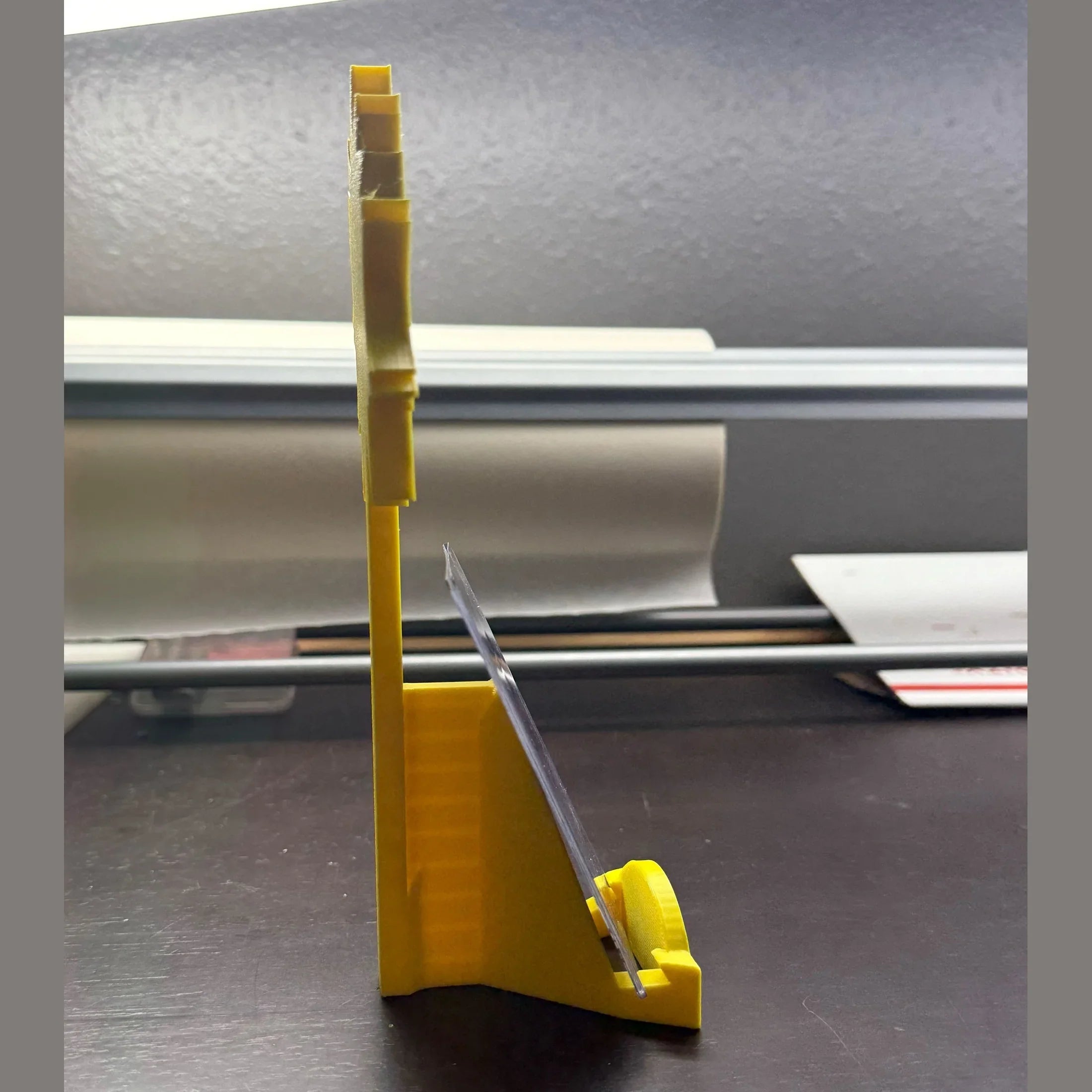 Yellow plastic tool on a metallic surface