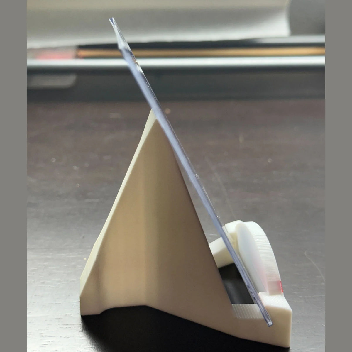 Clear plastic strip on a beige stand with a blurred background