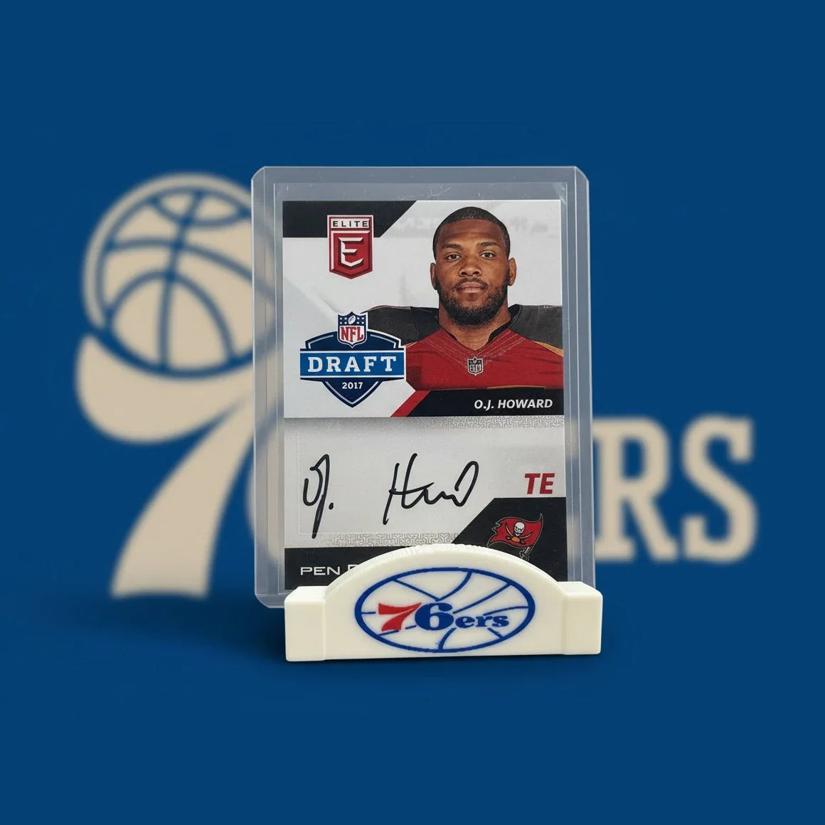 Trading card of O.J. Howard with a holder displaying the Philadelphia 76ers logo.