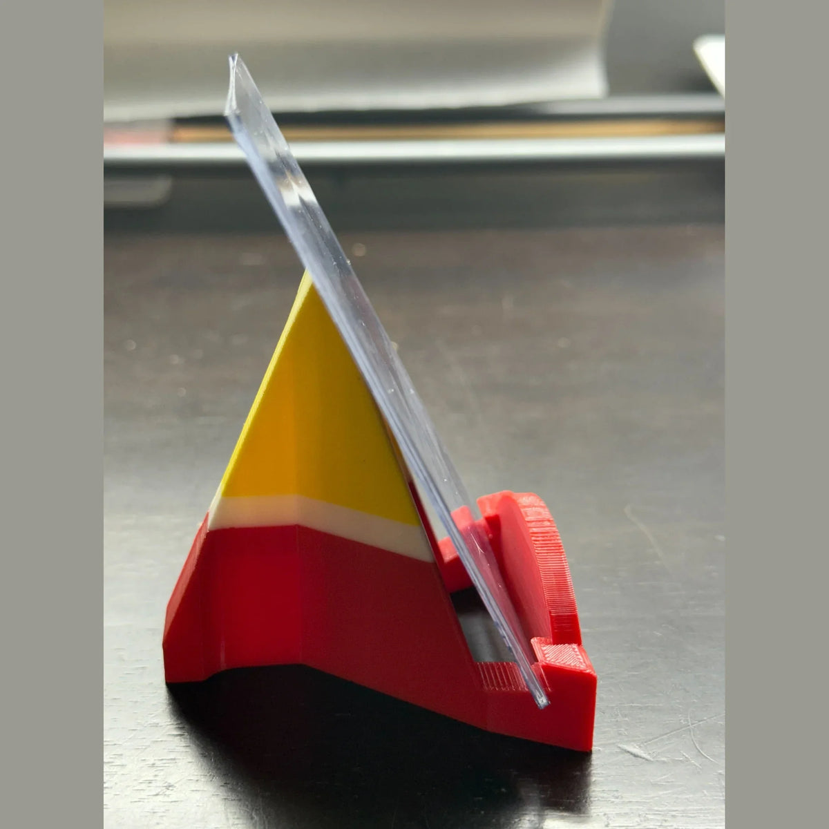 Red and yellow plastic tool on a metallic surface