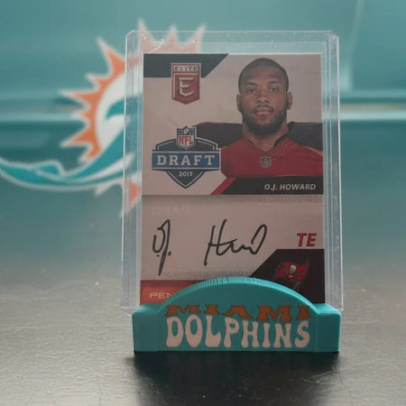 Football trading card of O.J. Howard with a clear holder on a metallic surface