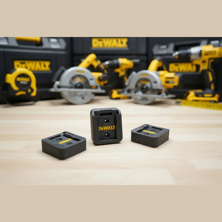 Three Dewalt plastic components on a metal surface