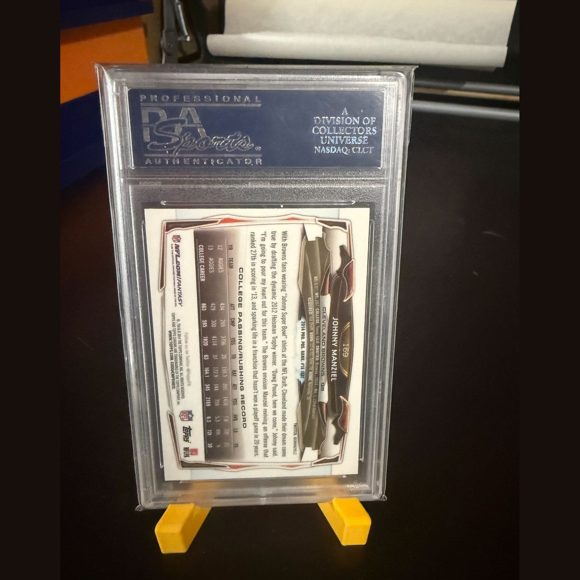 Trading card in a protective case with a grading label on a dark background