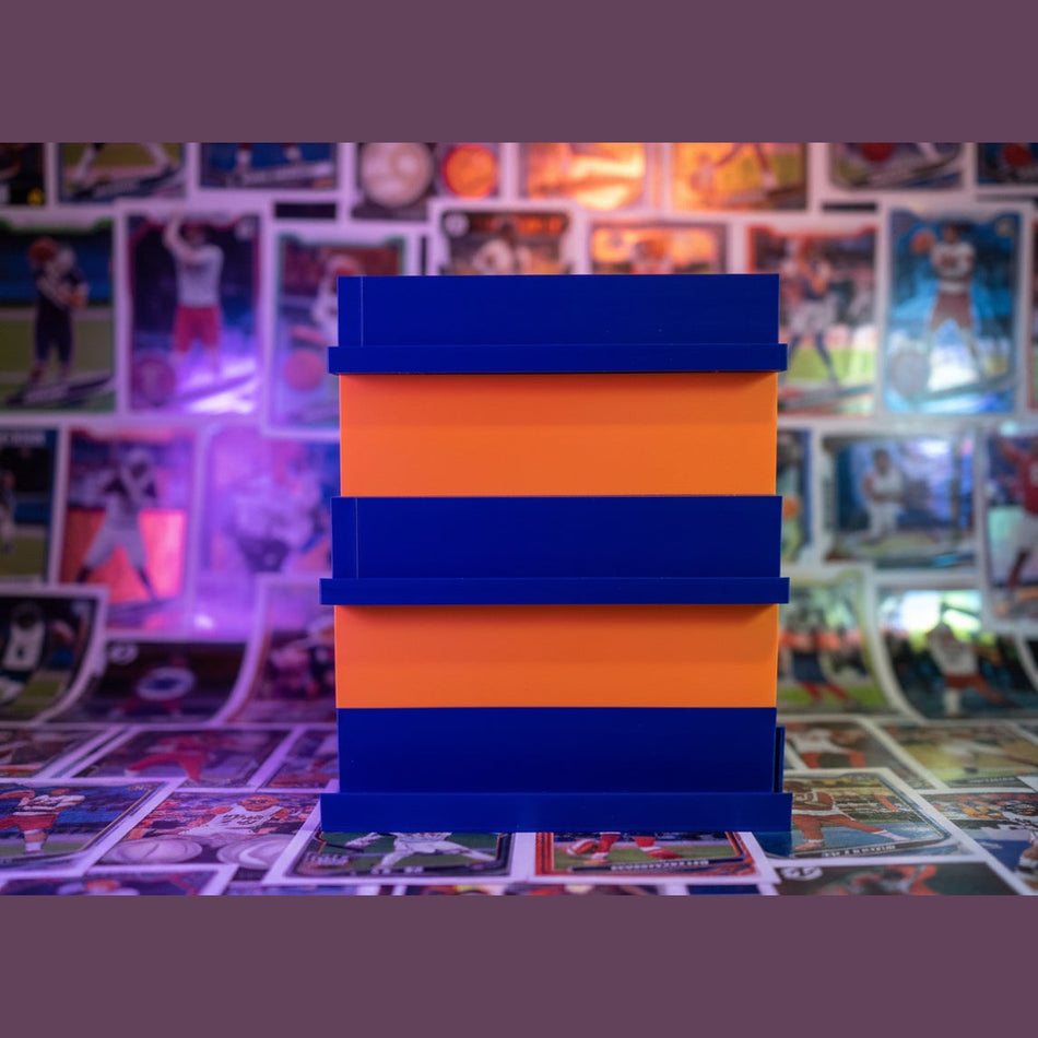 Stack of blue and orange rectangular blocks on a dark surface