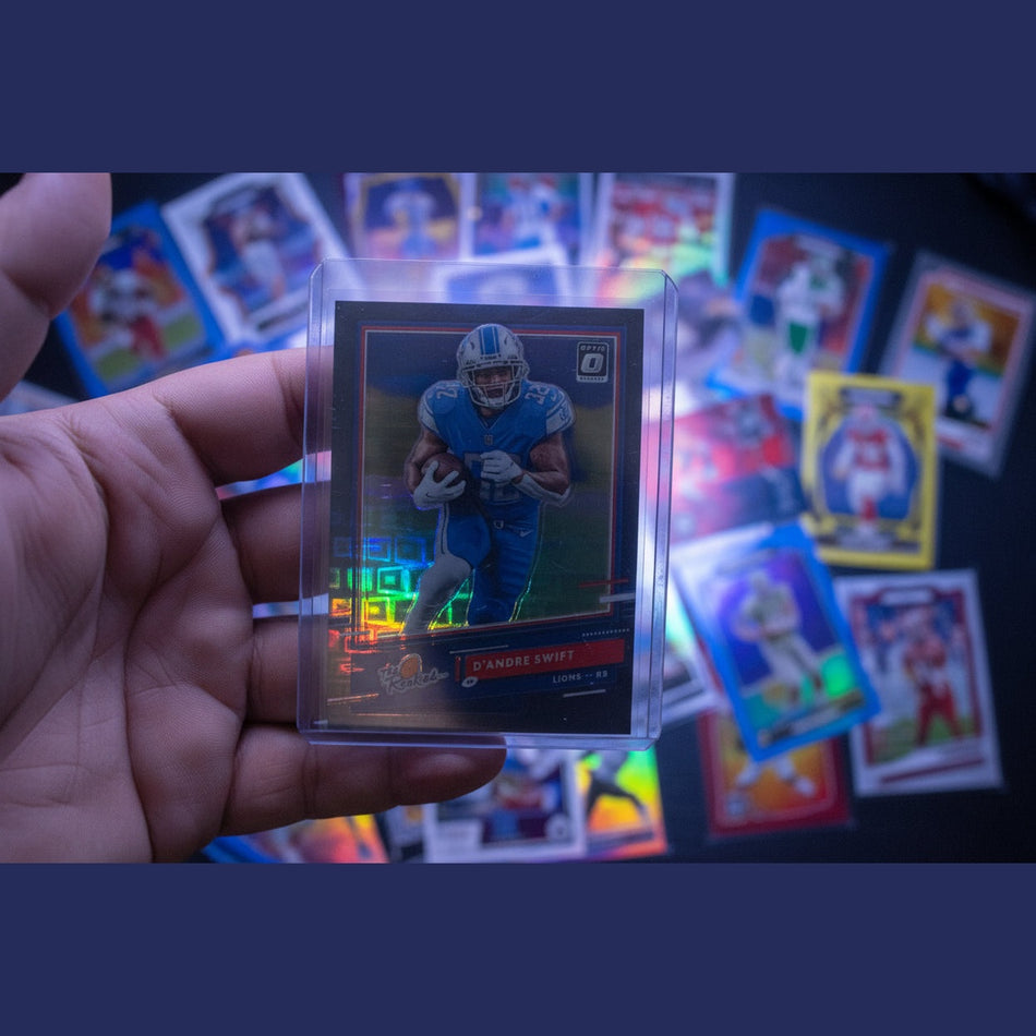 Football trading card of a player in a blue uniform held in a hand.