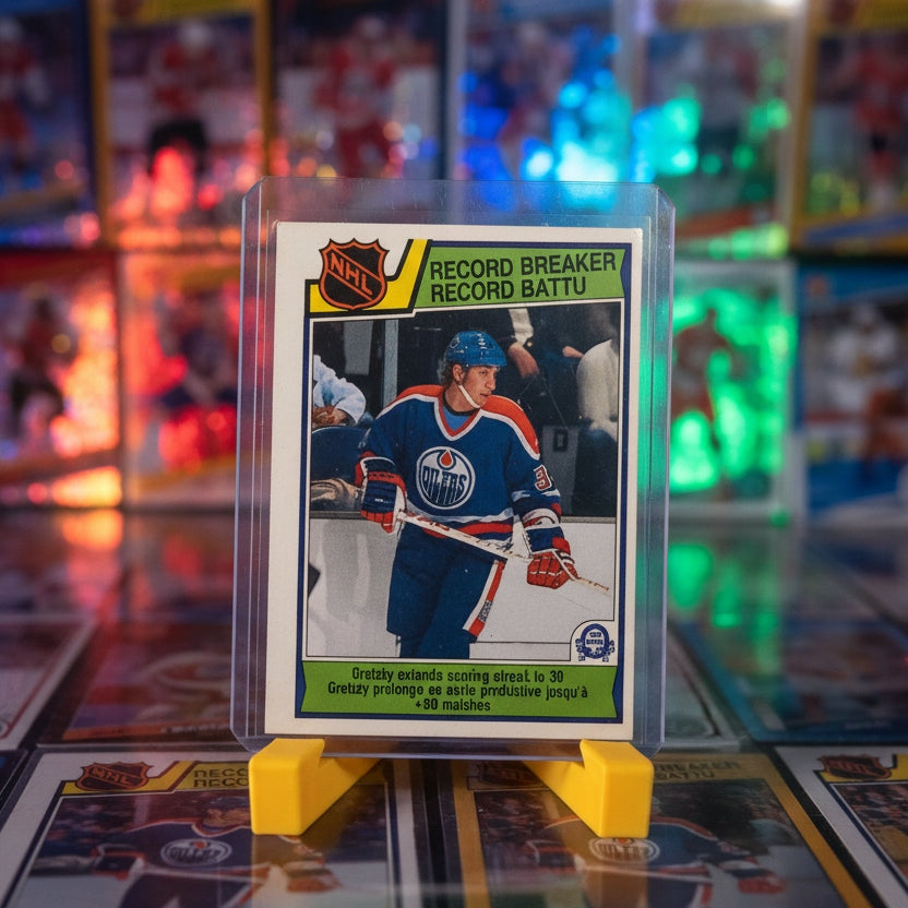 Hockey trading card featuring a player in a blue jersey on a black surface with a yellow card holder.