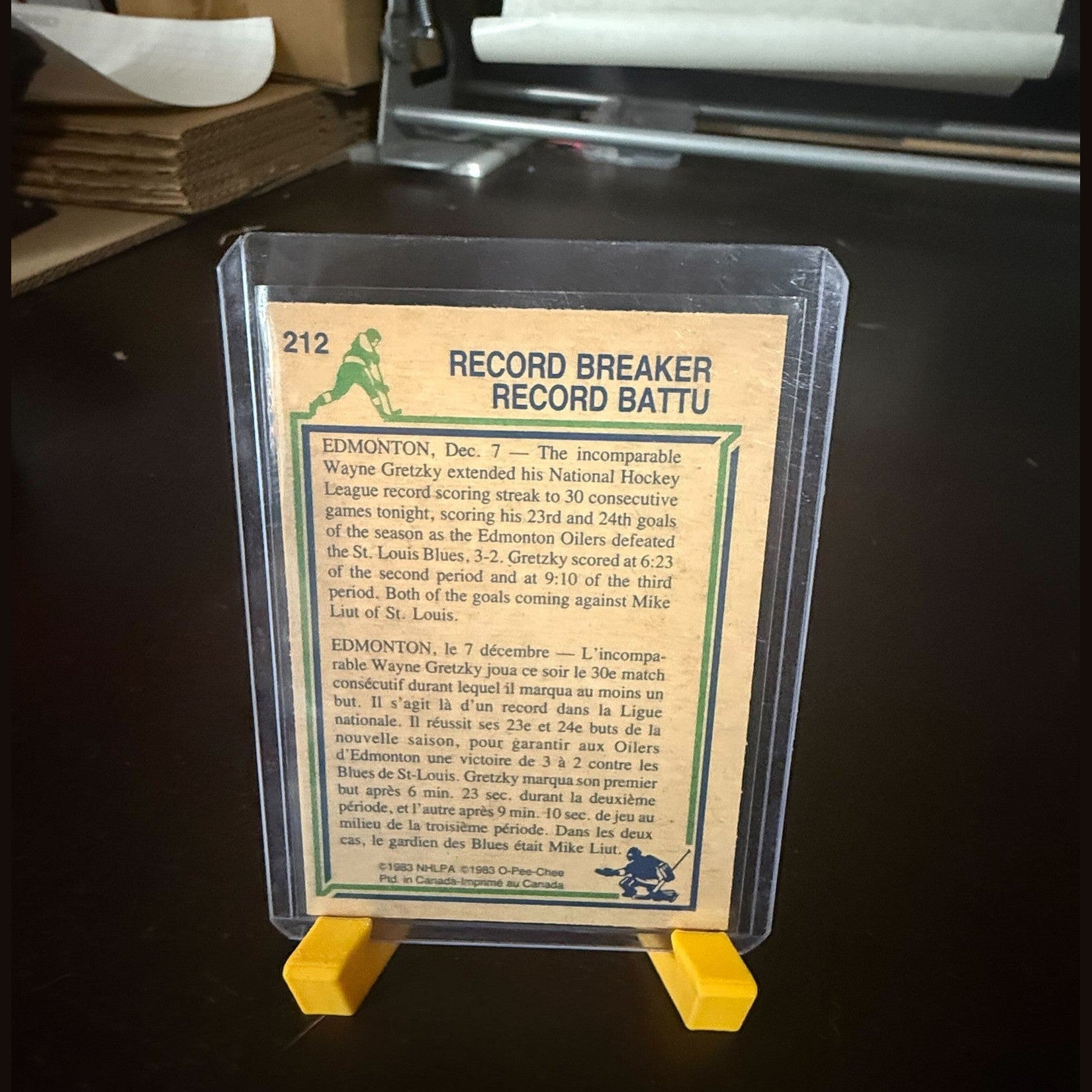 Vintage sports trading card in a protective case on a dark surface