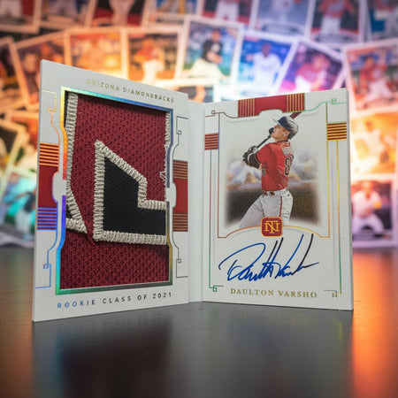 Baseball trading card with a player's signature on a dark surface