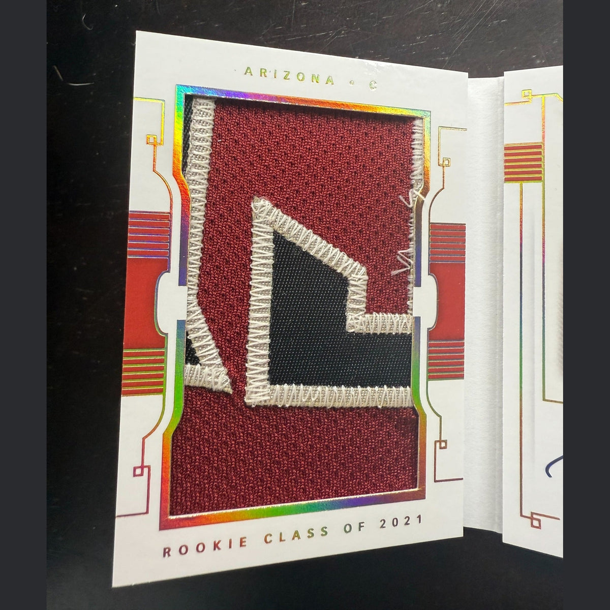 Card with a red and white patch on a black background