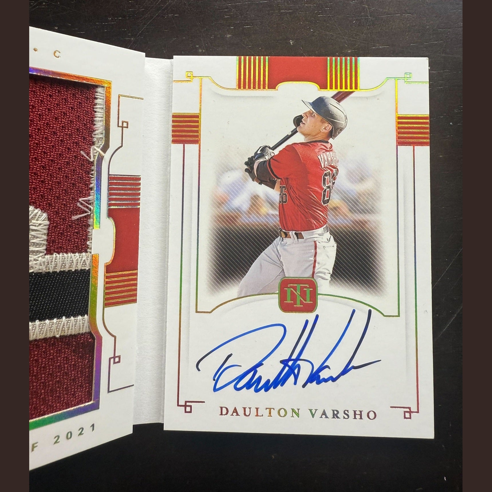 Baseball trading card of Daulton Varsho with autograph on a black background