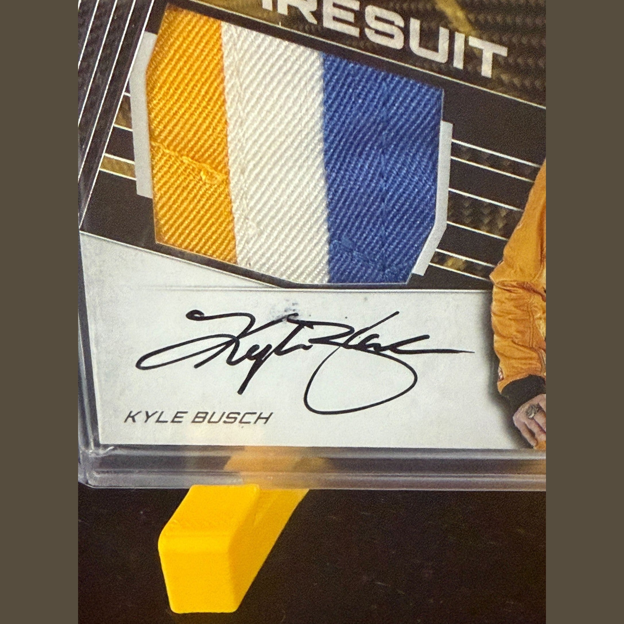 Trading card of Kyle Busch with signature and color swatches
