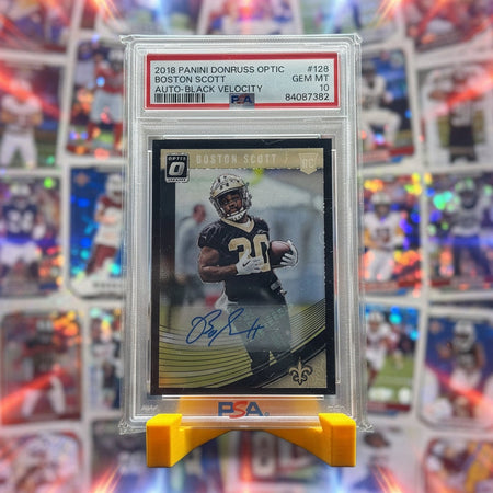 Football trading card in a protective case on a stand with a blurred background